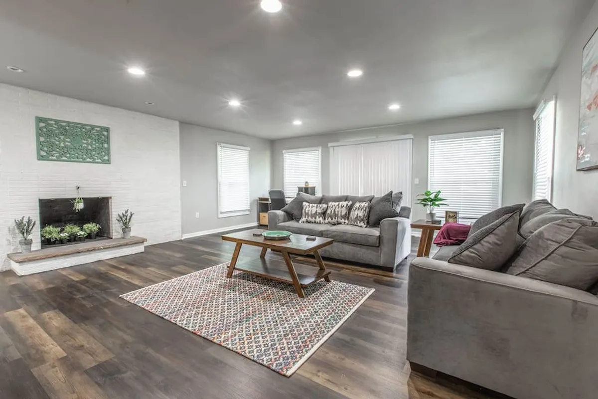 A comfortable, inviting lounge area featuring a cozy fireplace, a soft sofa, and a coffee table. The setting is intimate and perfect for relaxing evenings or socializing after a night out in the city.